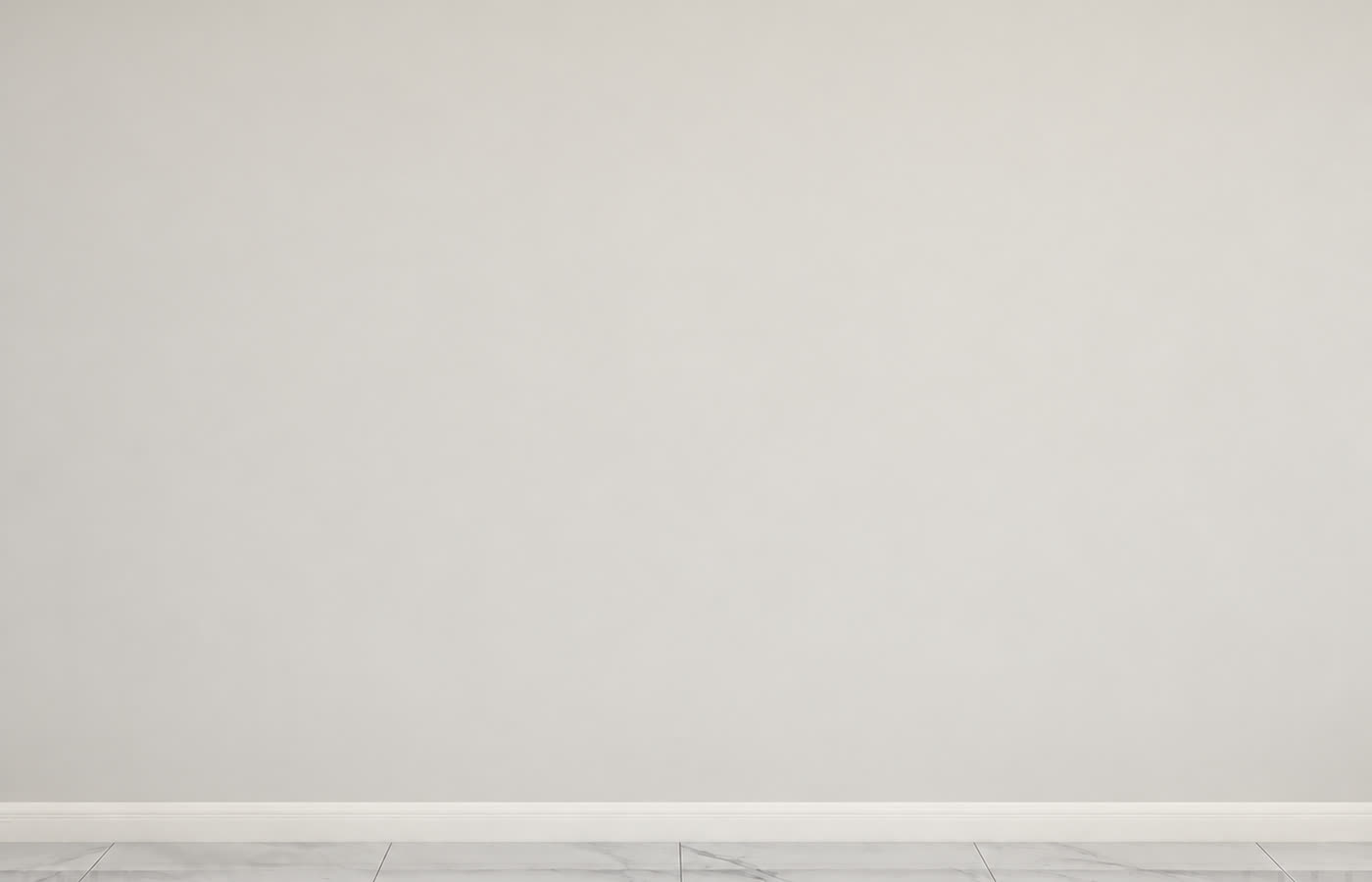The same room before work started: a bare plaster wall above marble tiled flooring